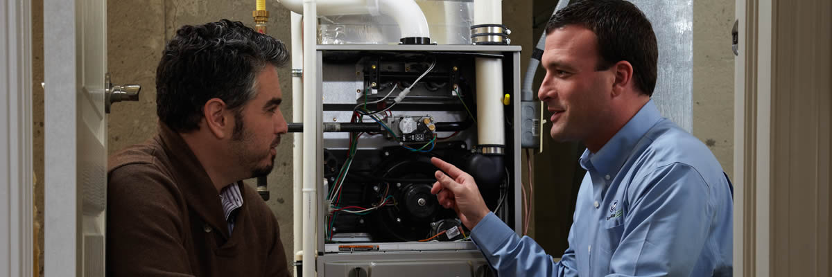 Hvac Tech Talking To Homeowner About Furnace Repair